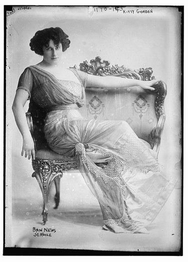 Victorian actress in an ornate loveseat
