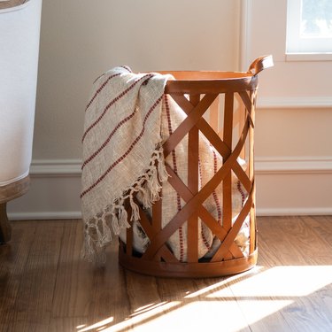 leather strap basket with striped blanket