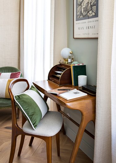 desk space with green pillow on chair
