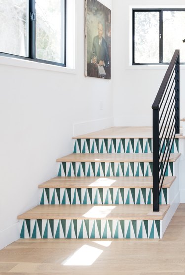 stairs decoration with blue and white tile and vintage painting on wall