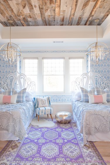 rustic girls bedroom idea with wood ceiling and patterned blue wallpaper