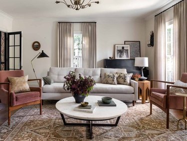 living room space with gray couch, two chairs and white coffee table