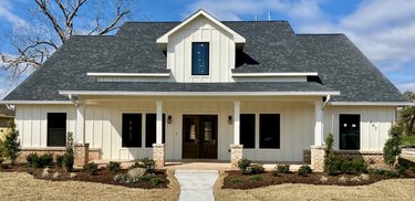 traditional home exterior idea of white house with accent lighting on the front porch