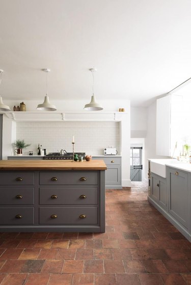 Kitchen floor tile idea with gray cabinets and brick floor