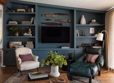 Moody blue media cabinet with wall-mounted flat screen