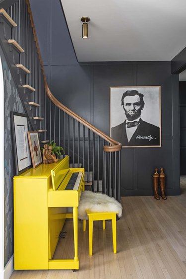 gray foyer with yellow piano