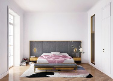 white bedroom with charcoal color headboard and large bed