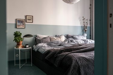 colors that go with blue, bedroom with color blocking on walls and neutral gray bedding and lighting