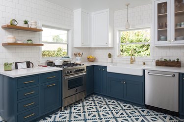 Patterned kitchen floor tile idea with blue cabinets and open shelving