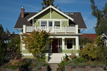 traditional home exterior idea of green house with red accent door