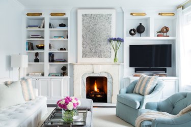 light blue traditional living room with open shelving and blue decor