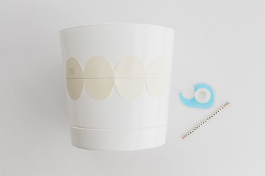 Tape the design in place on your pot and trace it.
