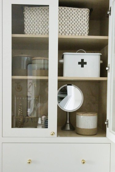 Bathroom organization idea with white cabinet
