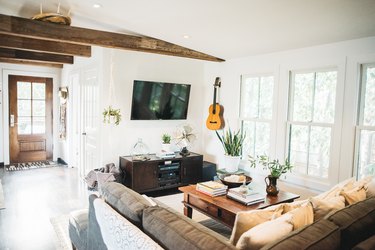 Bohemian living room idea with exposed wood beams and comfy sofas