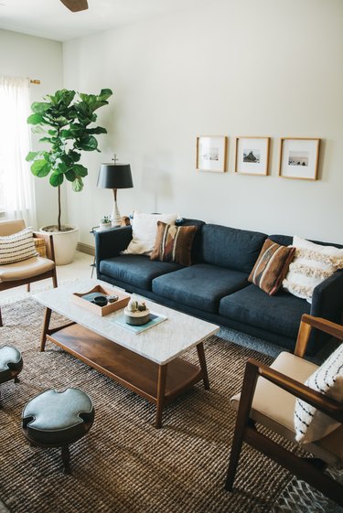 Modern bohemian living room idea with blue sofa and plants