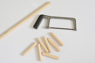 Wooden dowel cut into smaller pieces with hacksaw