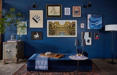 blue paint color in living room wall with gallery wall and daybed