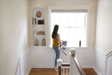 Woman sitting at bay window