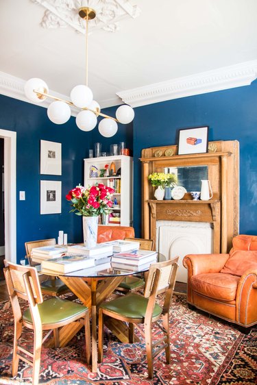 blue paint color in dining room with fireplace and dining room table