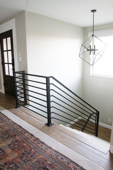 modern black stair railing with pendant