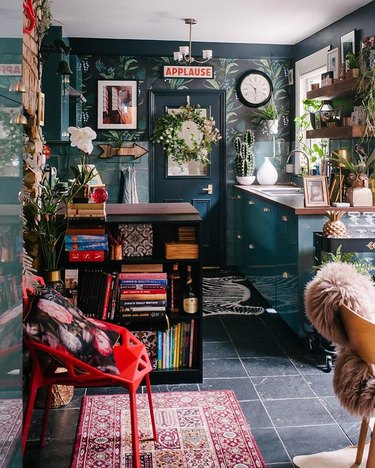 maximalist kitchen with botanical wallpaper and green cabinets