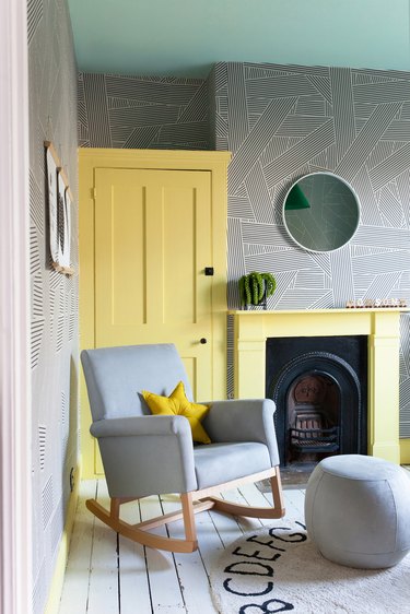 room with yellow door and fireplace
