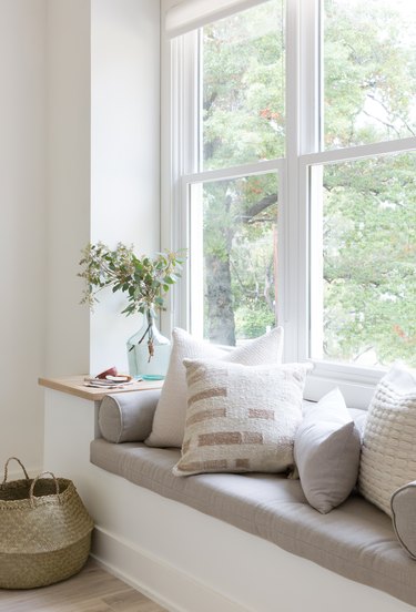 white nook with window bench seating with pullows