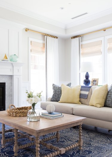 beige living room idea with yellow and blue accents by Studio McGee