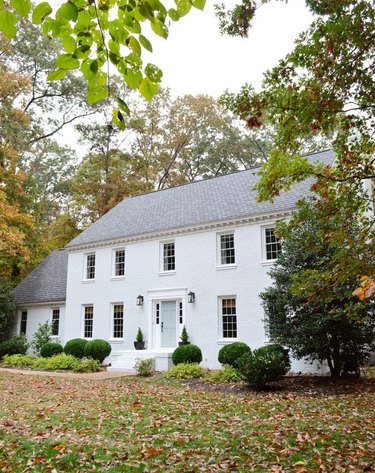 Traditional brick home painted white with colonial style architecture