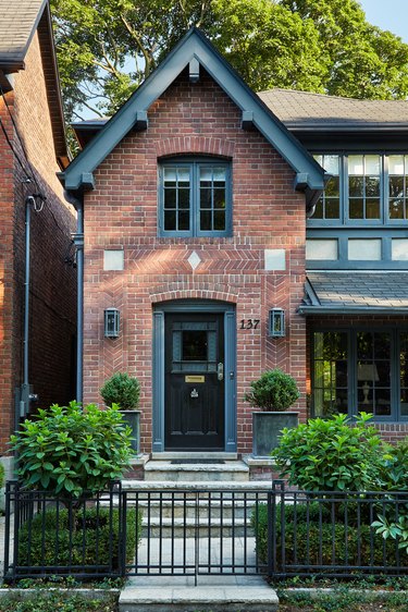 Traditional brick home with chevron patterning around front door