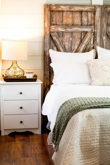 barn door DIY rustic headboard in farmhouse bedroom