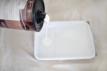 pouring paint into tray