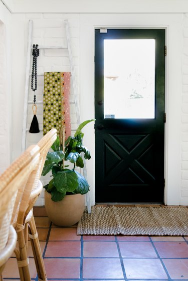 Plants and textiles hang on a vintage ladder.