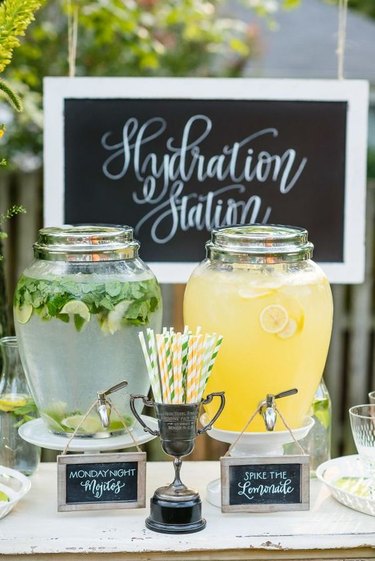 outdoor bar with drinks dispensers and handmade signs
