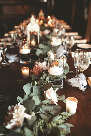 country table setting with candles, lanterns and fresh flowers