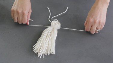 Tying a knot around the tassel