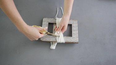 Cutting yarn off the picture frame
