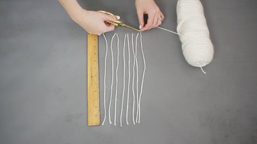 Cutting eight 12-inch yarn strands