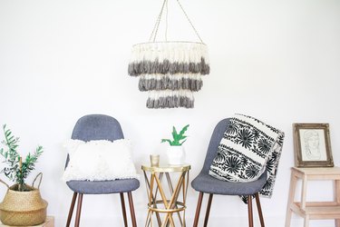Tassel chandelier hanging above two chairs