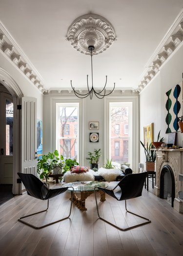 white living room with floor to ceiling windows and classic molding