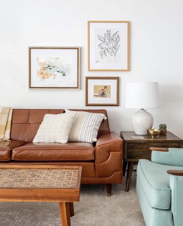 vintage living room idea with a brown fake leather couch and robin's egg blue armchair, both vintage