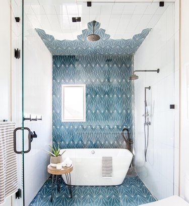 bathroom shower idea with freestanding bathtub and blue tile accent wall
