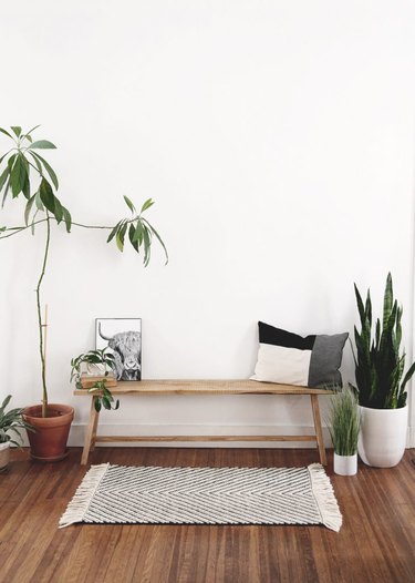 white room with wood floors and diy rustic decor wooden bench