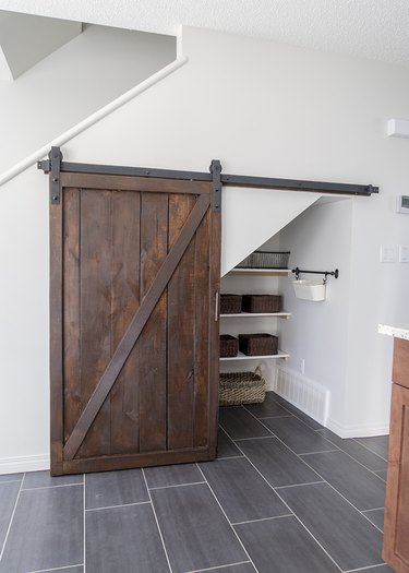 diy rustic decor barn door cover space under the stairs