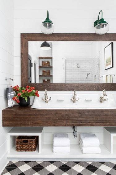 Farmhouse bathroom storage designed by Chango & Co. with under the sink storage