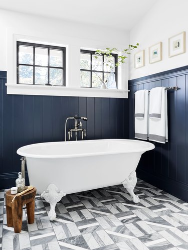 bathroom floor tile idea with blue wainscoting and patterned tile with clawfoot tub