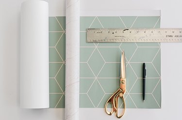 Measure and cut out patterned paper to cover the top and sides of the IKEA cat house.