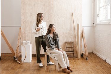 Nicole Mason and her studio manager Annie in front of the plywood backdrop at The Portland Studio