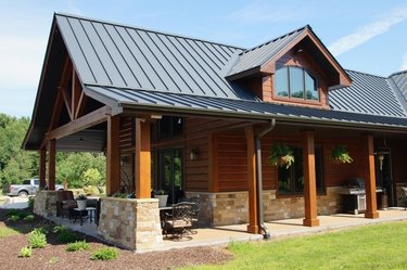 Standing seam metal roof on log cabin.