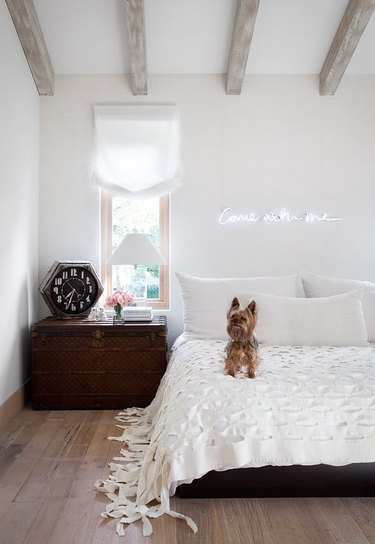 neon sign in rustic white bedroom